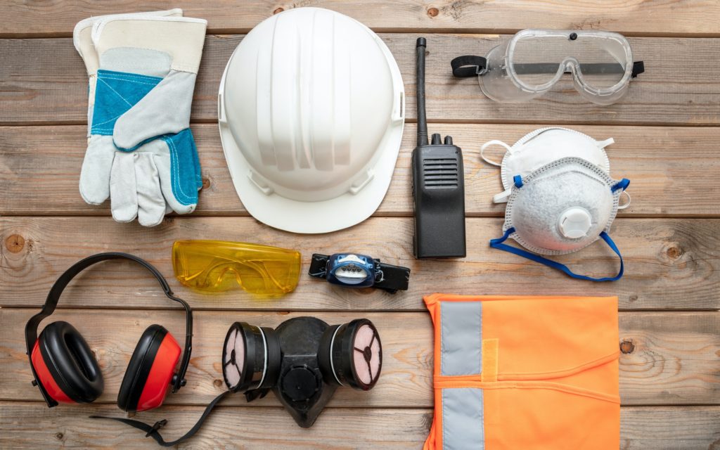 Work safety protection equipment. flat lay on wooden background.